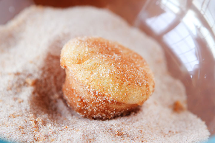 Strawberry Shortcake Doughnut Muffins. These are like little bites of HEAVEN. A muffin that tastes like a doughnut, dunked in brown butter and rolled in cinnamon sugar for a sweet, crunchy crust. Then topped with buttercream frosting and fresh cut strawberries. Amazing.