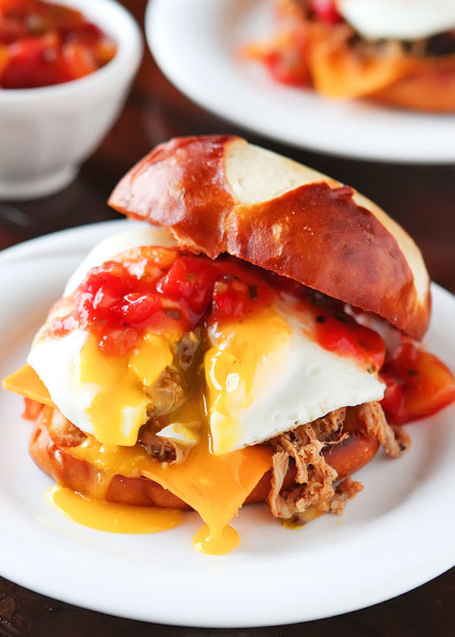 Caribbean Pulled Pork Sandwiches. Spicy pulled pork topped with a sweet mango-peach salsa, a runny fried egg and served on a buttery pretzel bun. He took one bite and said, “Can we have this again tomorrow night?”