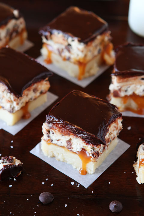 Cookie Dough Billionaire Bars. The most amazing dessert you can bring to a potluck ever. 4 Layers of Shortbread, Salted Caramel Sauce, Cookie Dough, and homemade Chocolate Ganache.