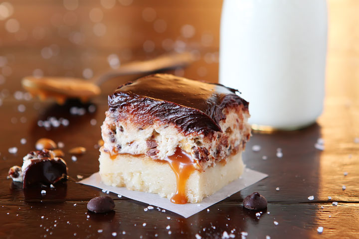 Cookie Dough Billionaire Bars. The most amazing dessert you can bring to a potluck ever. 4 Layers of Shortbread, Salted Caramel Sauce, Cookie Dough, and homemade Chocolate Ganache.