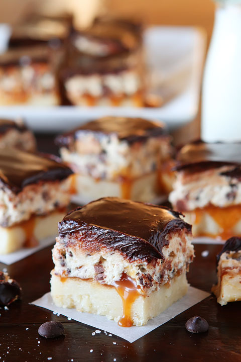 Cookie Dough Billionaire Bars. The most amazing dessert you can bring to a potluck ever. 4 Layers of Shortbread, Salted Caramel Sauce, Cookie Dough, and homemade Chocolate Ganache.