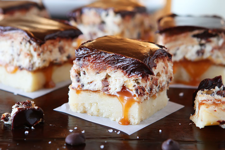 Cookie Dough Billionaire Bars. The most amazing dessert you can bring to a potluck ever. 4 Layers of Shortbread, Salted Caramel Sauce, Cookie Dough, and homemade Chocolate Ganache.