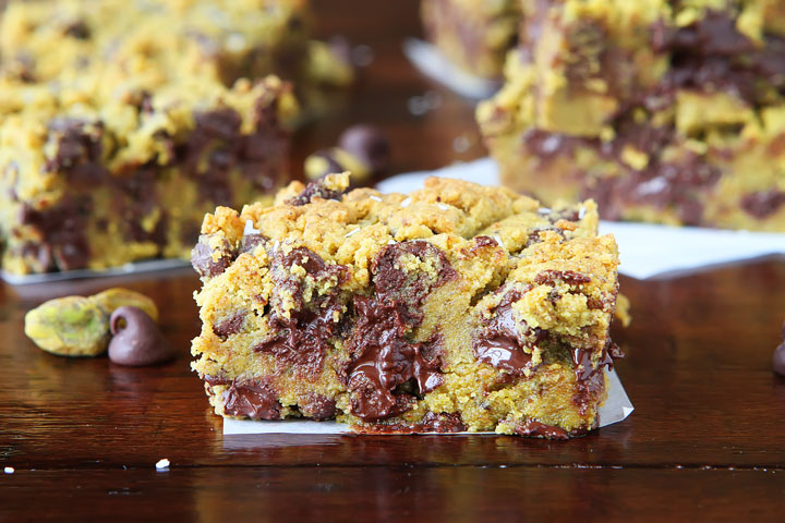 Lucky Leprechaun Bars! So good, they're sure to attract a Leprechaun and his pot of gold. ;) Dark chocolate, pistachio butter, and sea salt come together to make this perfect chewy cookie bar. Make these the next time you need a little luck in your day!