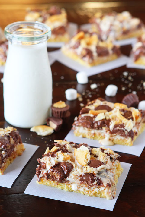 Gooey Ritz Peanut Butter Cup S'mores Bars! Buttery cake topped with marshmallow fluff, mini peanut butter cups and Ritz crackers. If these bars were a person, we'd be married and on our third kid.