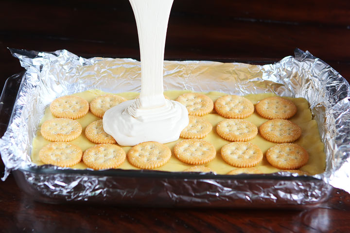 Gooey Ritz Peanut Butter Cup S'mores Bars! Buttery cake topped with marshmallow fluff, mini peanut butter cups and Ritz crackers. If these bars were a person, we'd be married and on our third kid.