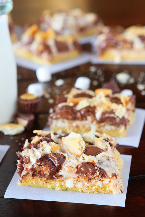 Gooey Ritz Peanut Butter Cup S'mores Bars! Buttery cake topped with marshmallow fluff, mini peanut butter cups and Ritz crackers. If these bars were a person, we'd be married and on our third kid.