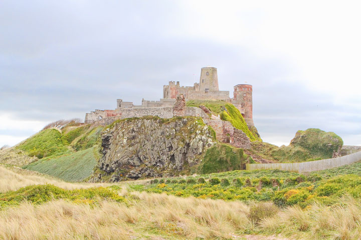 Visit Bamburgh Castle on a castle drive down the coast of Scotland + More Tips for Traveling to Scotland from www.kevinandamanda.com.