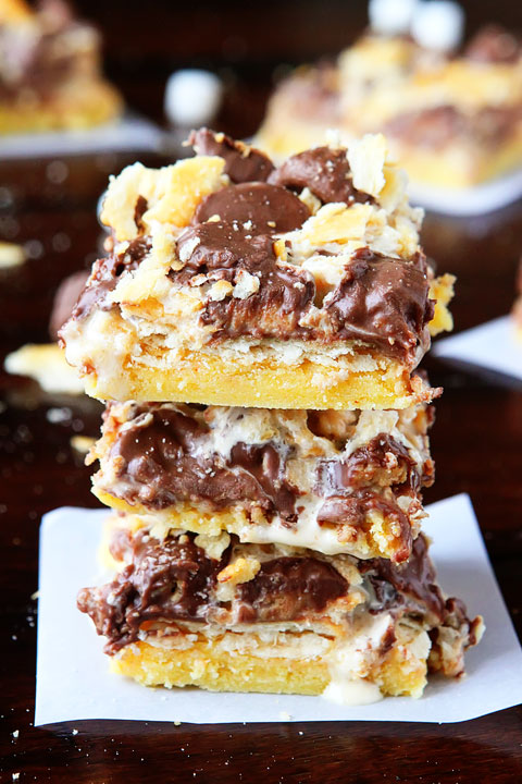 Gooey Ritz Peanut Butter Cup S'mores Bars! Buttery cake topped with marshmallow fluff, mini peanut butter cups and Ritz crackers. If these bars were a person, we'd be married and on our third kid.
