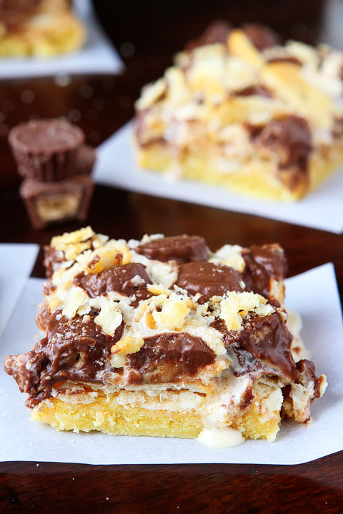 Gooey Ritz Peanut Butter Cup S'mores Bars! Buttery cake topped with marshmallow fluff, mini peanut butter cups and Ritz crackers. If these bars were a person, we'd be married and on our third kid.