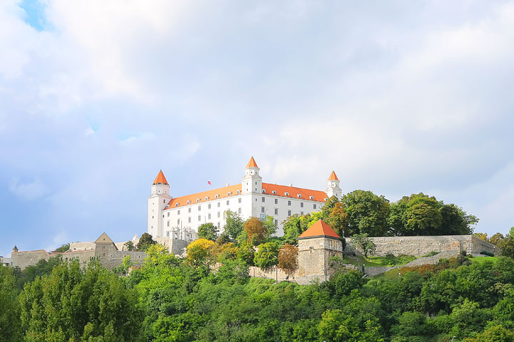 Fairytale castle with an orange roof high on a hill