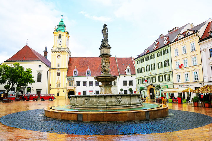 Historic fountain with colorful houses