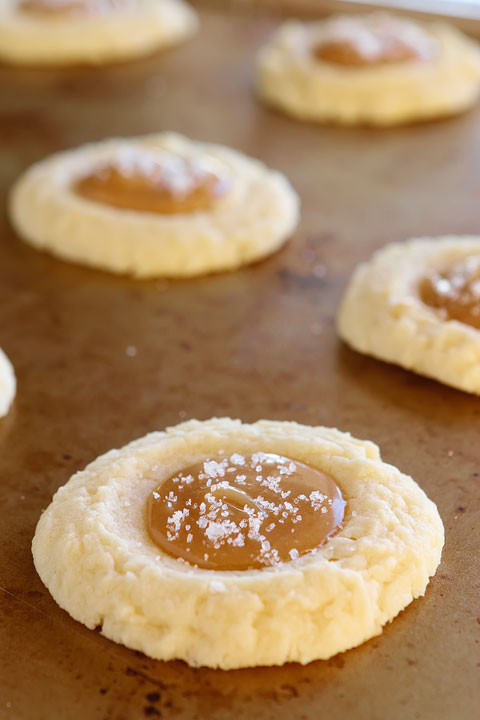 These Salted Caramel Cookies are SO soft and buttery. The perfect vanilla butter cookie! But topped with gooey salted caramel?? I die!! 