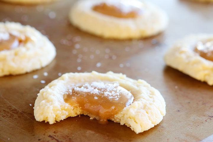 These Salted Caramel Cookies are SO soft and buttery. The perfect vanilla butter cookie! But topped with gooey salted caramel?? I die!! 