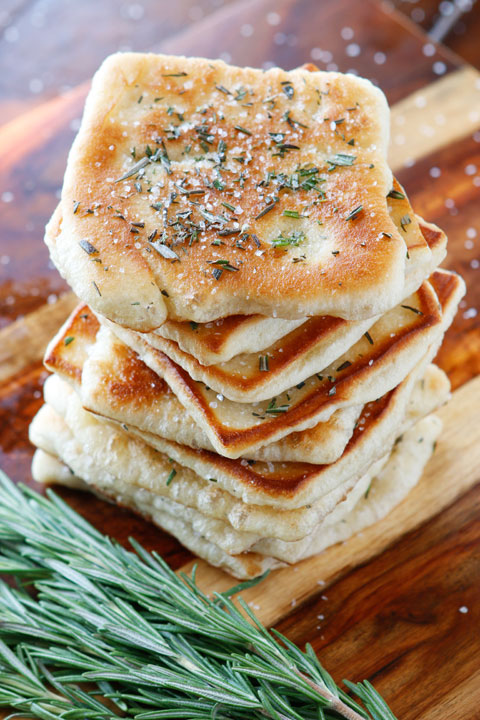 The PERFECT appetizer or side dish to serve with dinner! This bread is SO quick and easy to whip up. It's lightly fried in olive oil and topped with fresh rosemary and sea salt. The perfect combination!! You have to make this!!