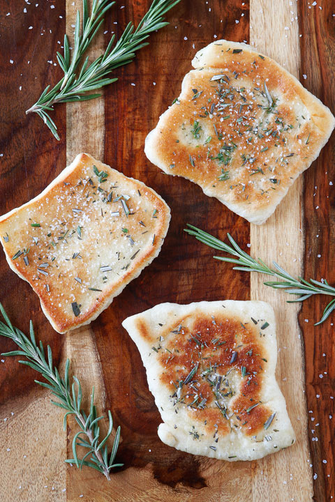 The PERFECT appetizer or side dish to serve with dinner! This bread is SO quick and easy to whip up. It's lightly fried in olive oil and topped with fresh rosemary and sea salt. The perfect combination!! You have to make this!!