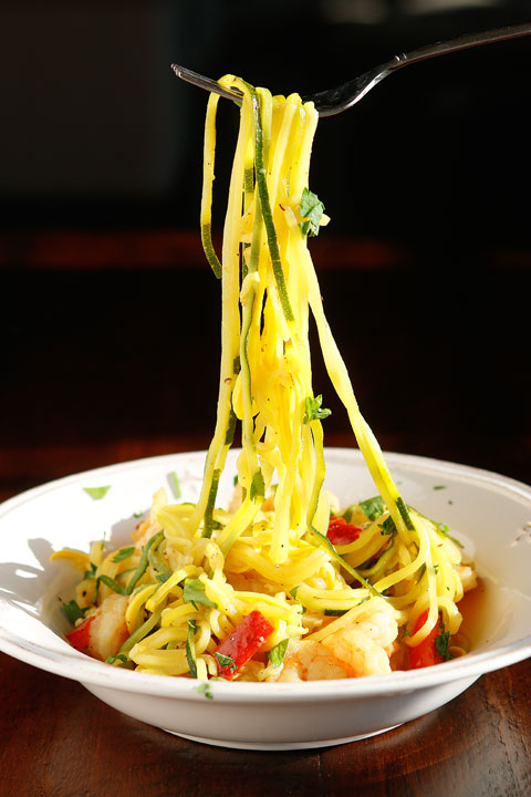 The PERFECT summer recipe!! Sautéed shrimp and red bell peppers poured over a bed of spiralized zucchini and yellow squash. So easy and delicious!