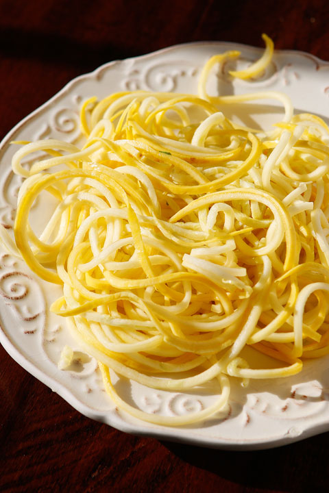 The PERFECT summer recipe!! Sautéed shrimp and red bell peppers poured over a bed of spiralized zucchini and yellow squash. So easy and delicious!