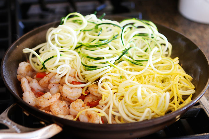 The PERFECT summer recipe!! Sautéed shrimp and red bell peppers poured over a bed of spiralized zucchini and yellow squash. So easy and delicious!