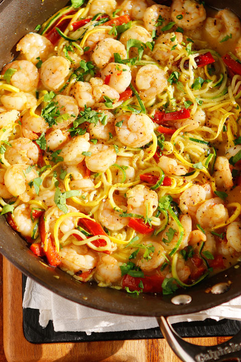 The PERFECT summer recipe!! Sautéed shrimp and red bell peppers poured over a bed of spiralized zucchini and yellow squash. So easy and delicious!