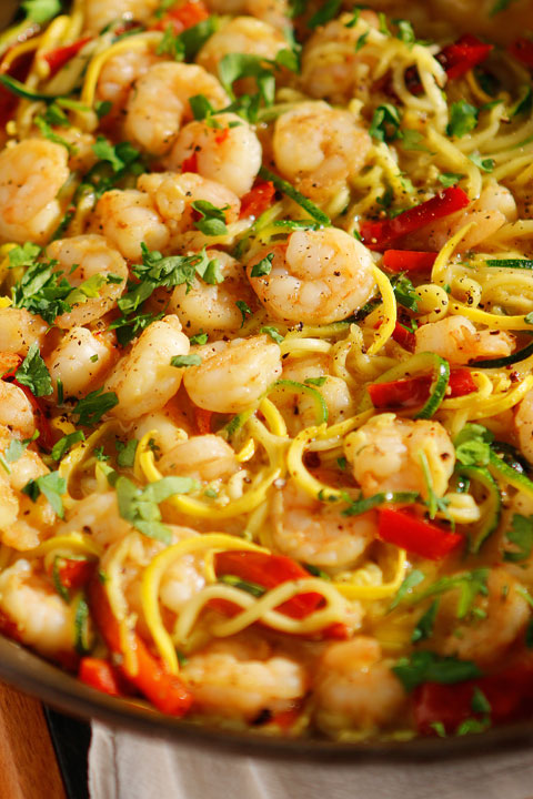 The PERFECT summer recipe!! Sautéed shrimp and red bell peppers poured over a bed of spiralized zucchini and yellow squash. So easy and delicious!