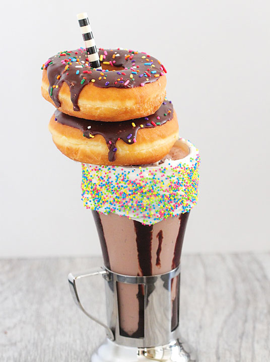 Chocolate Doughnut Milkshake!! Crazy milkshakes are all the hype in NYC, London, and Australia. Now you can skip the flight and 3-4 hour wait in line and make them right at home!! Such a fun idea for a party. MUST try this!!