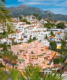 Pink Building with mountain in background in Nerja Spain