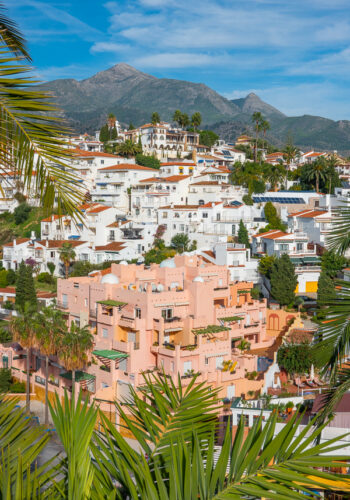 Pink Building with mountain in background in Nerja Spain