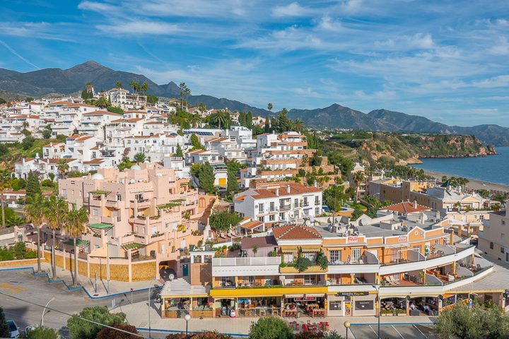 Pink Building with mountain in background in Nerja Spain