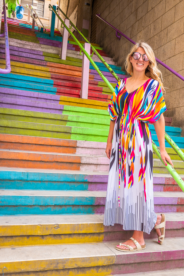 Girl in colorful dress on Rainbow Stairs in Amman Jordan