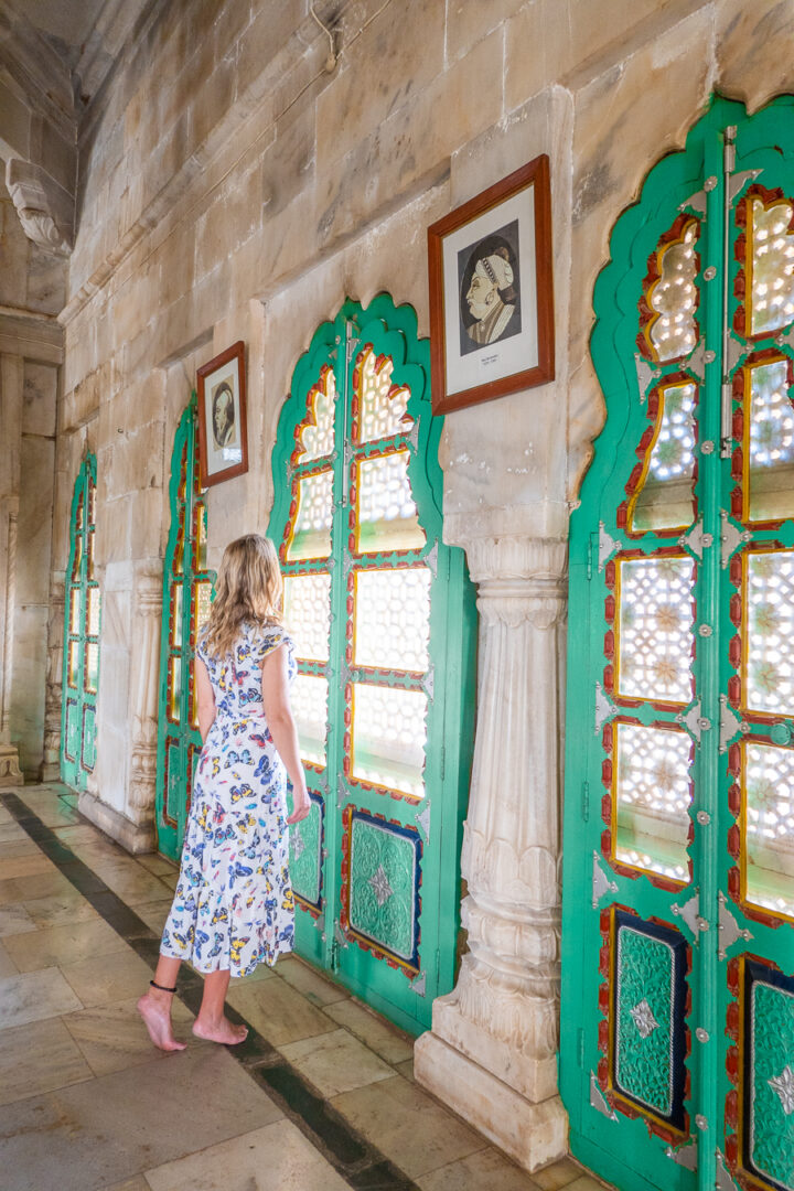 Woman looking at photos of the past kings of Jodhpur, India