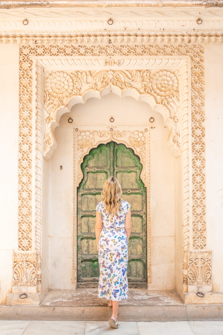 Blonde woman in front of green door at at Merangherang Fort