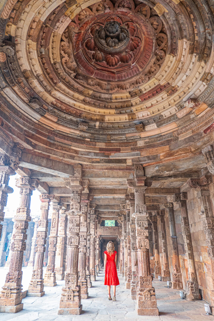 Girl in red dress at Qutub Minar in New Delhi