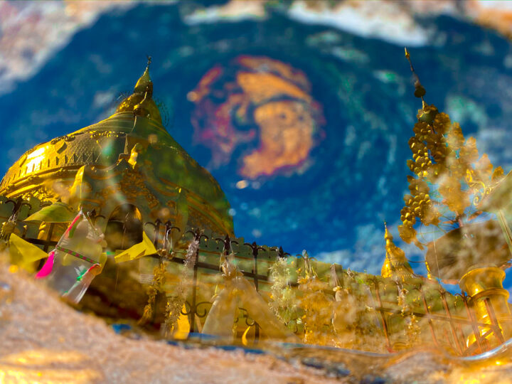 Image of the gold plated Shwezigon Pagoda in Bagan, Myanmar from the reflecting pool located in front of the pagoda. 