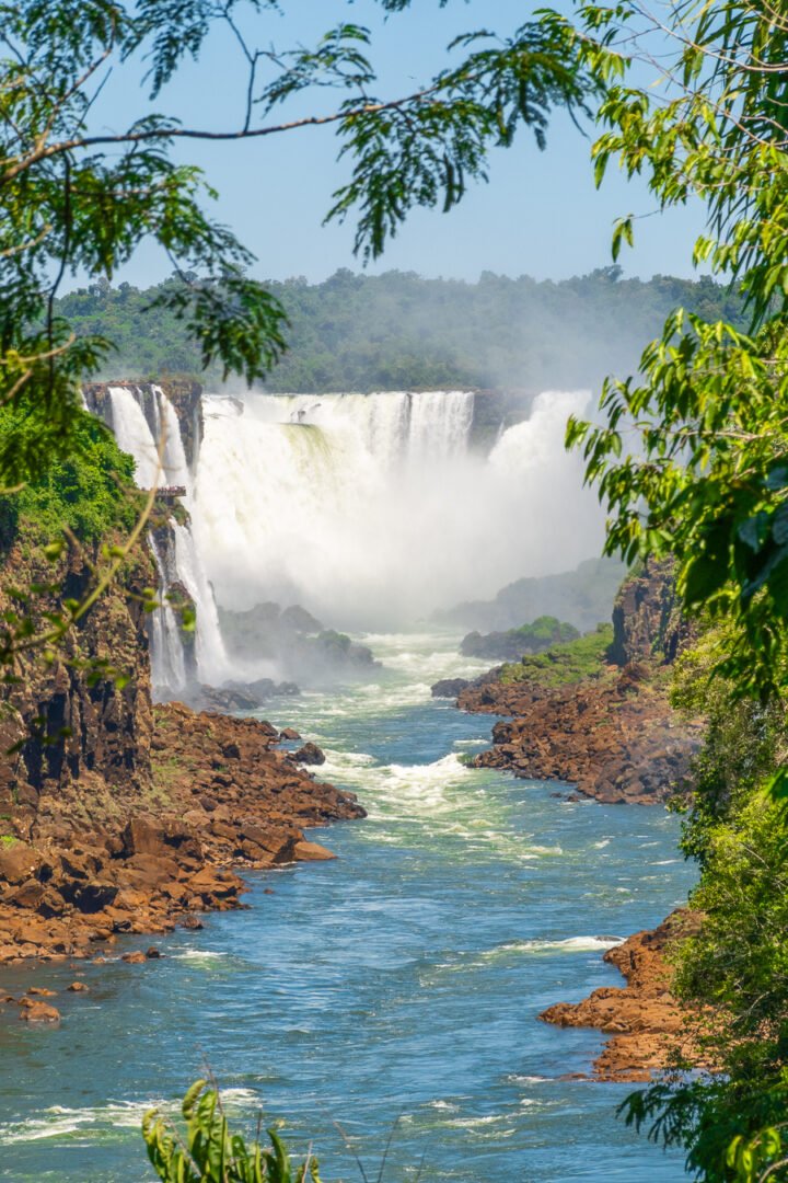 View of Iguazu Falls through trees  from Argentina.