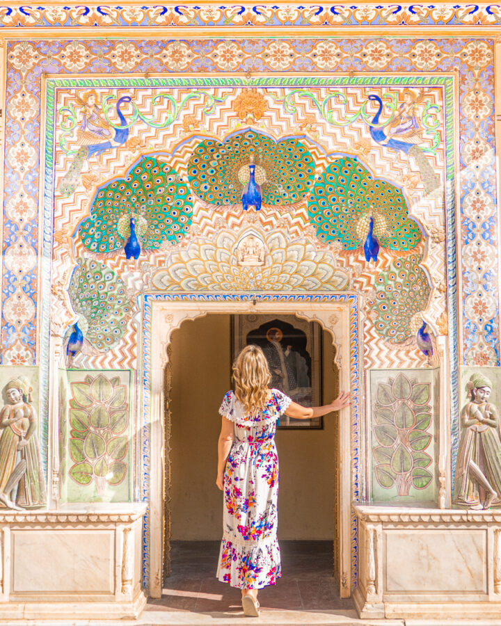 A visitor entering the Peacock Gate at Pritam Niwas Chowk at Jaipur, India.