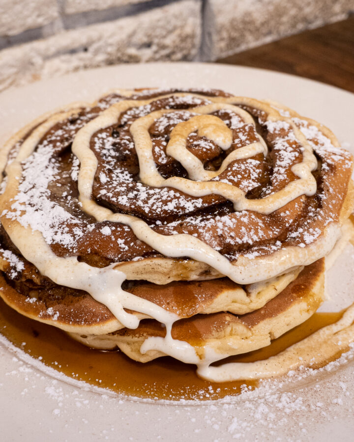 stack cinnamon bun pancakes with swirled frosting from Jam Cafe