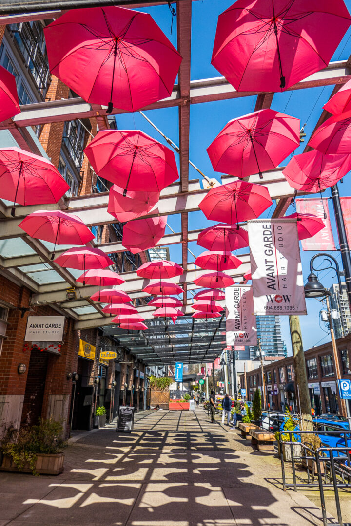 Red umbrellas hanging from above with shadows