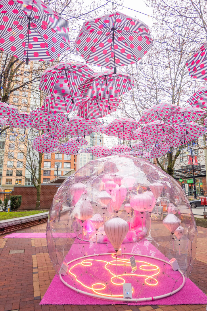 pink polka dot umbrellas hanging from above