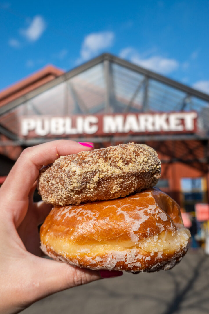 stacked donuts in front of the Public Market sign at Granville Island