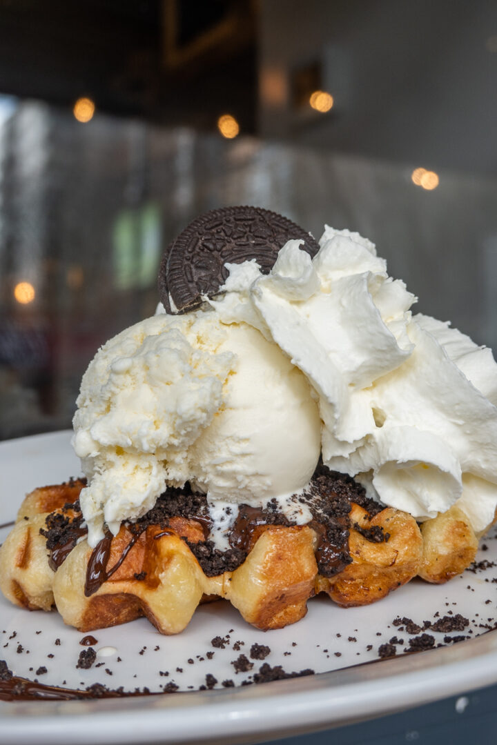 Liege waffle with ice cream, whipped cream, and chocolate sauce