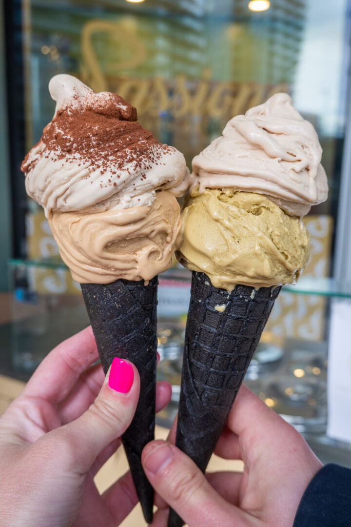 two waffle cones with two scoops of gelato