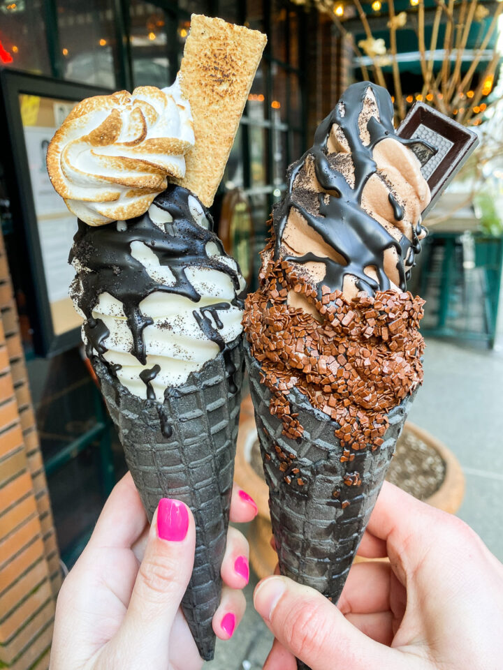 Vanilla and Chocolate soft serve ice cream with chocolate drizzle and black cones