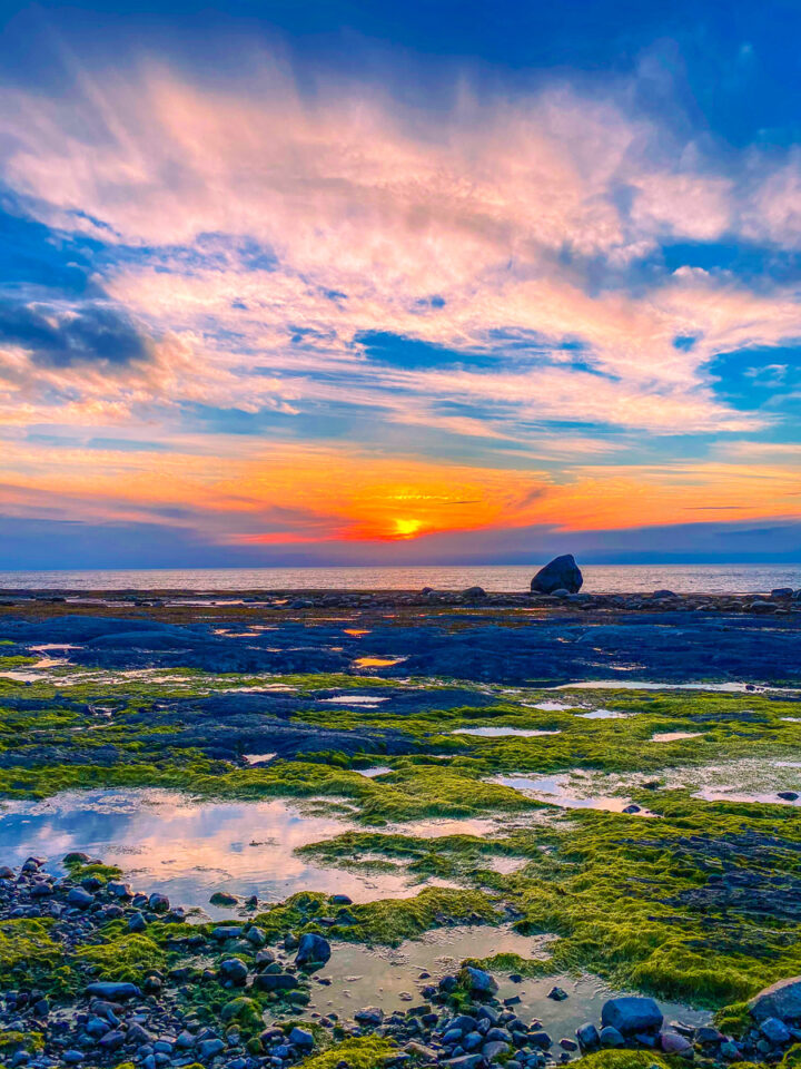 sunset with tide pools on the beach in Gaspesie