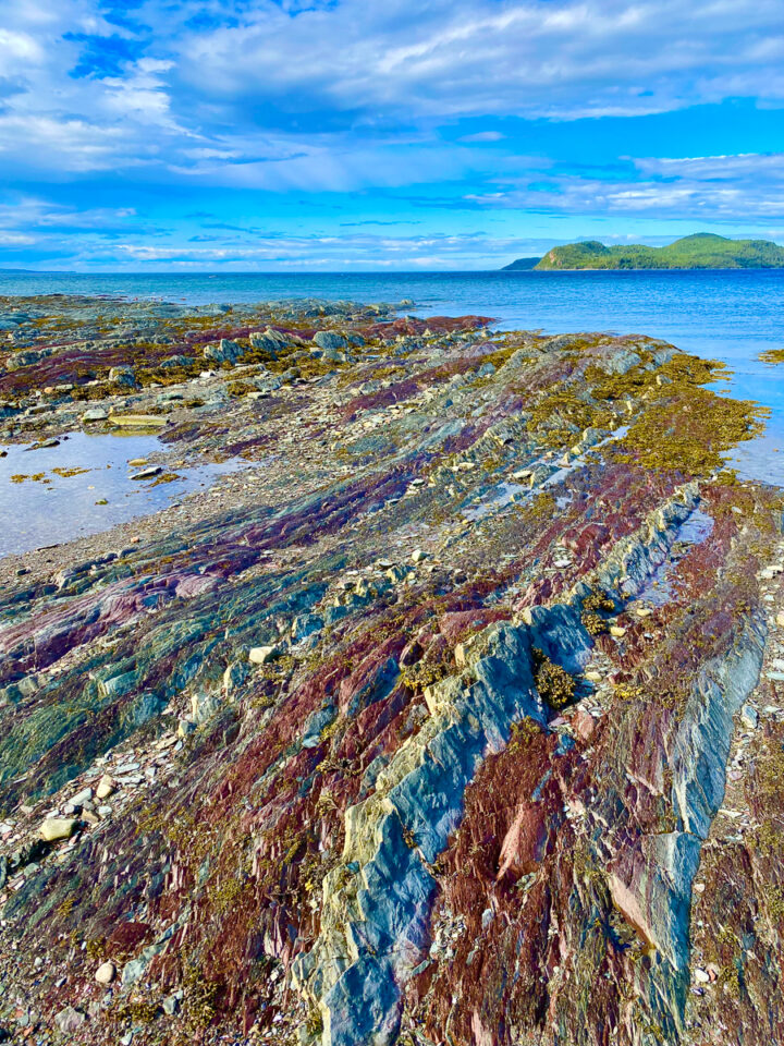 colorful rainbow rock formations on the beach at Bic National Park in Gaspesie