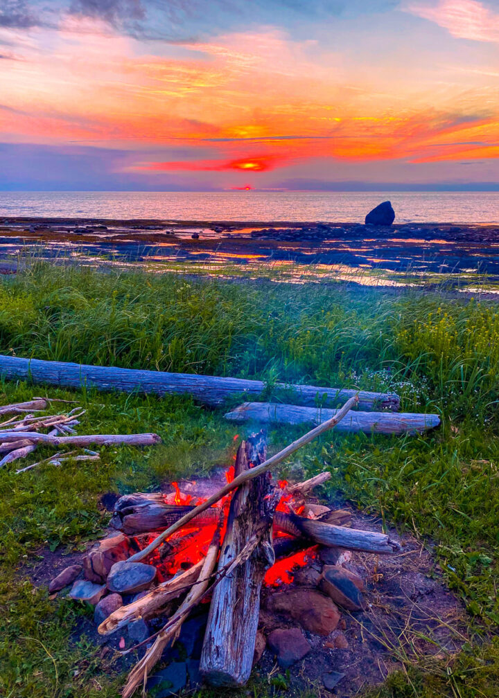 bonfire on the beach at sunset in Gaspesie