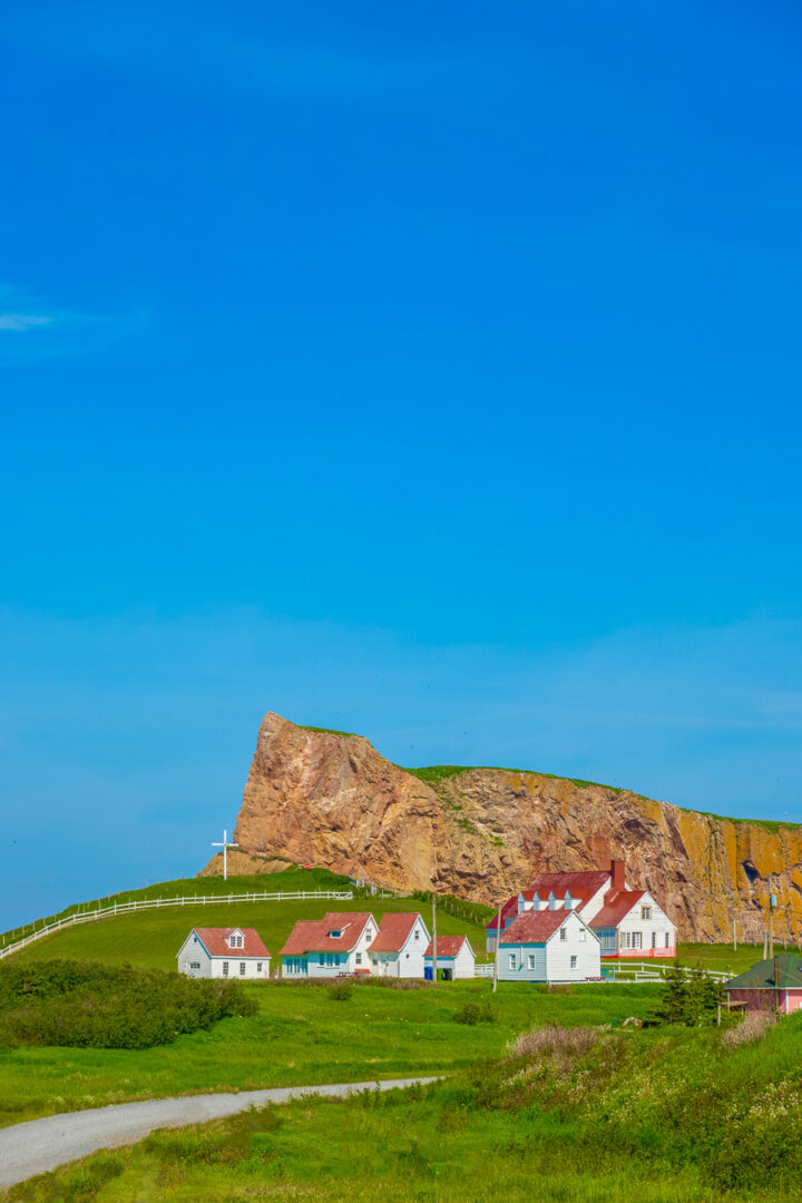 church with cross and red cliffs in perce quebec