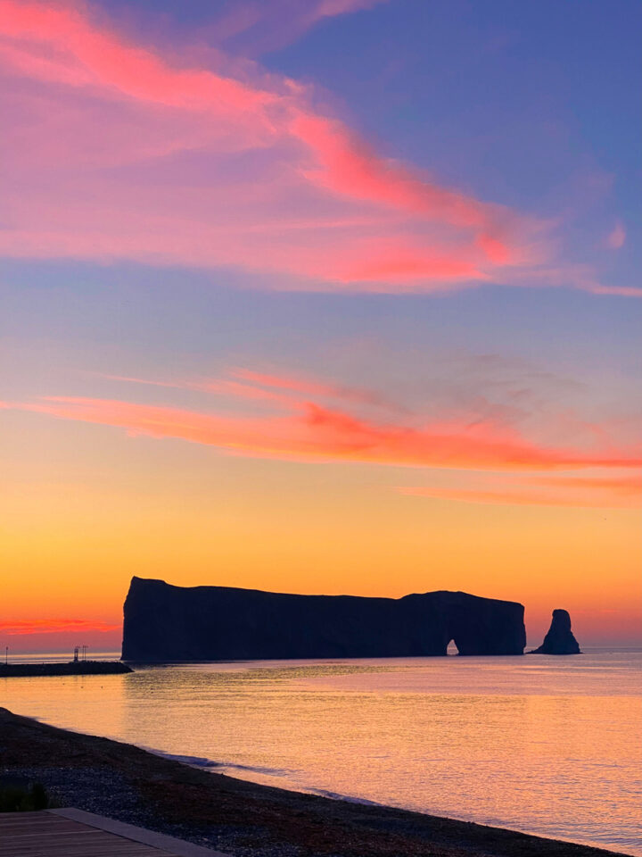 Perce Rock at sunrise with pink sky in Gaspesie